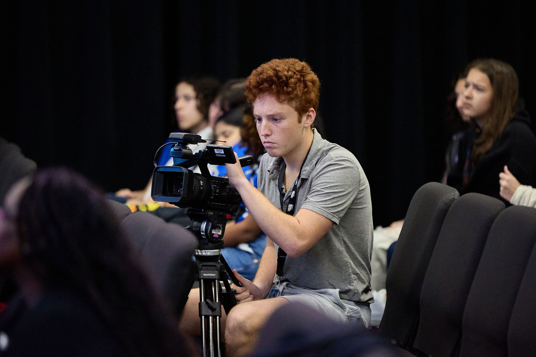 Carter Lutz operating a broadcast camera