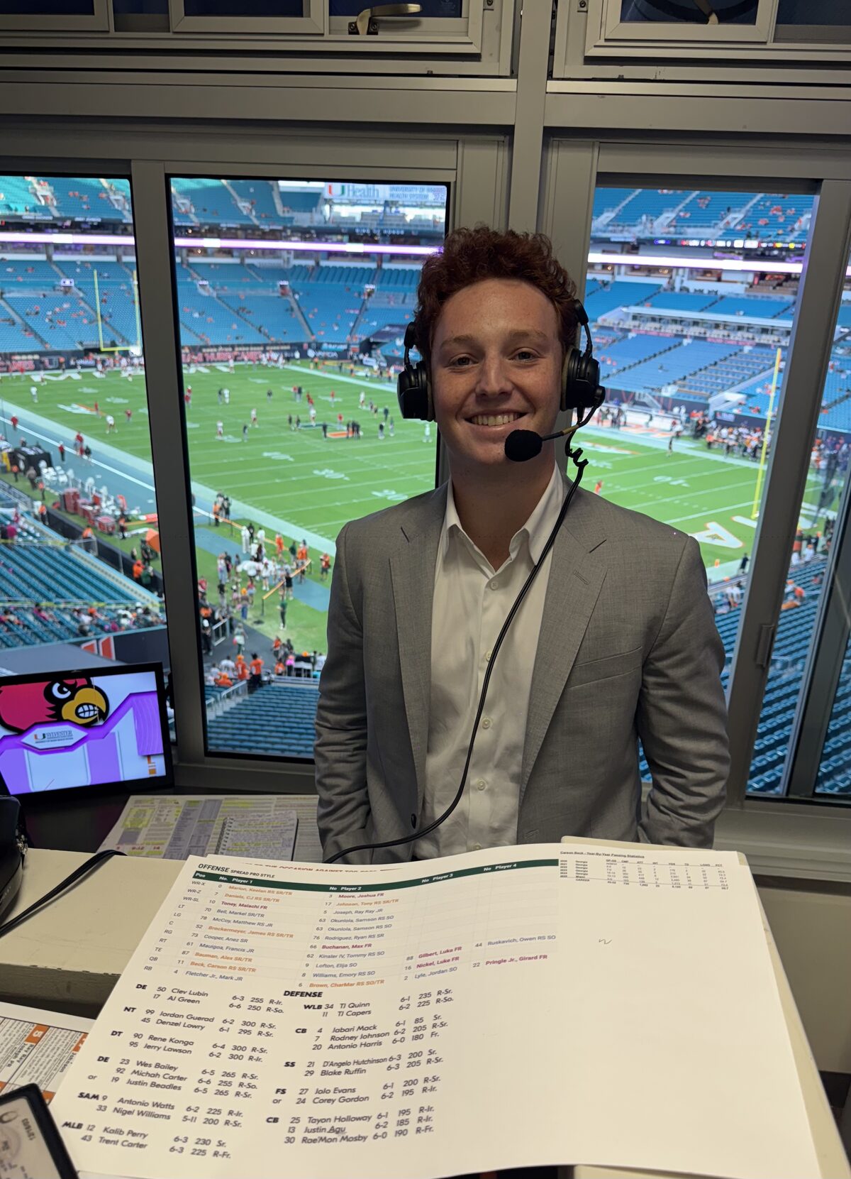 Carter Lutz in the broadcast booth at Hard Rock Stadium calling a Miami Hurricanes game